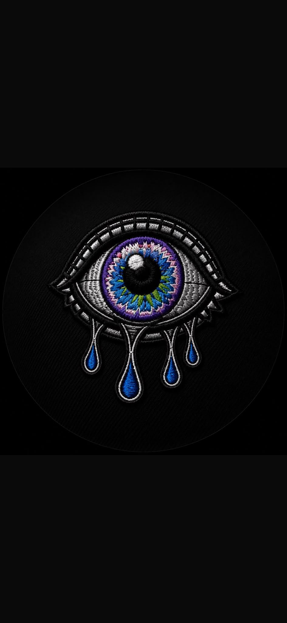Culloh’s signature eye, embroidered in purple, blue and white